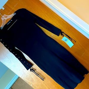 Black rayon/poly dress with ties up the sleeves. Size medium. NWT.